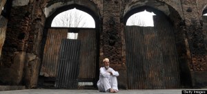 A Kashmiri Muslim man looks at the ruins of a revered 200-year old sufi shrine in downtown Srinagar on July 5,2012, which was gutted in a devasted fire recently.Thousands of devotees throng the place of worship daily and the number is expected to go-up tonight on the occassion of Shabi-e-barat, an auspicious night during which muslims offer special prayers seeking forgiveness from God.The shrine stood in Srinagar's khanyar locality in memory and respect of the 11th century sunni priest from persia Syed Abdul Qadir Geelani burried in Baghdad. AFP PHOTO/Tauseef MUSTAFA (Photo credit should read TAUSEEF MUSTAFA/AFP/GettyImages)